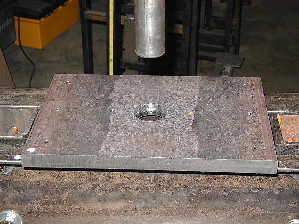 Shows alignment of the steel ram to the hole in the support plate