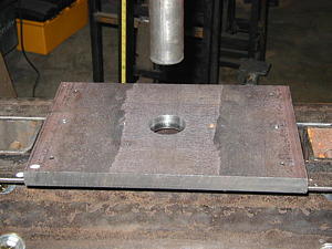 Shows alignment of the steel ram to the hole in the support plate